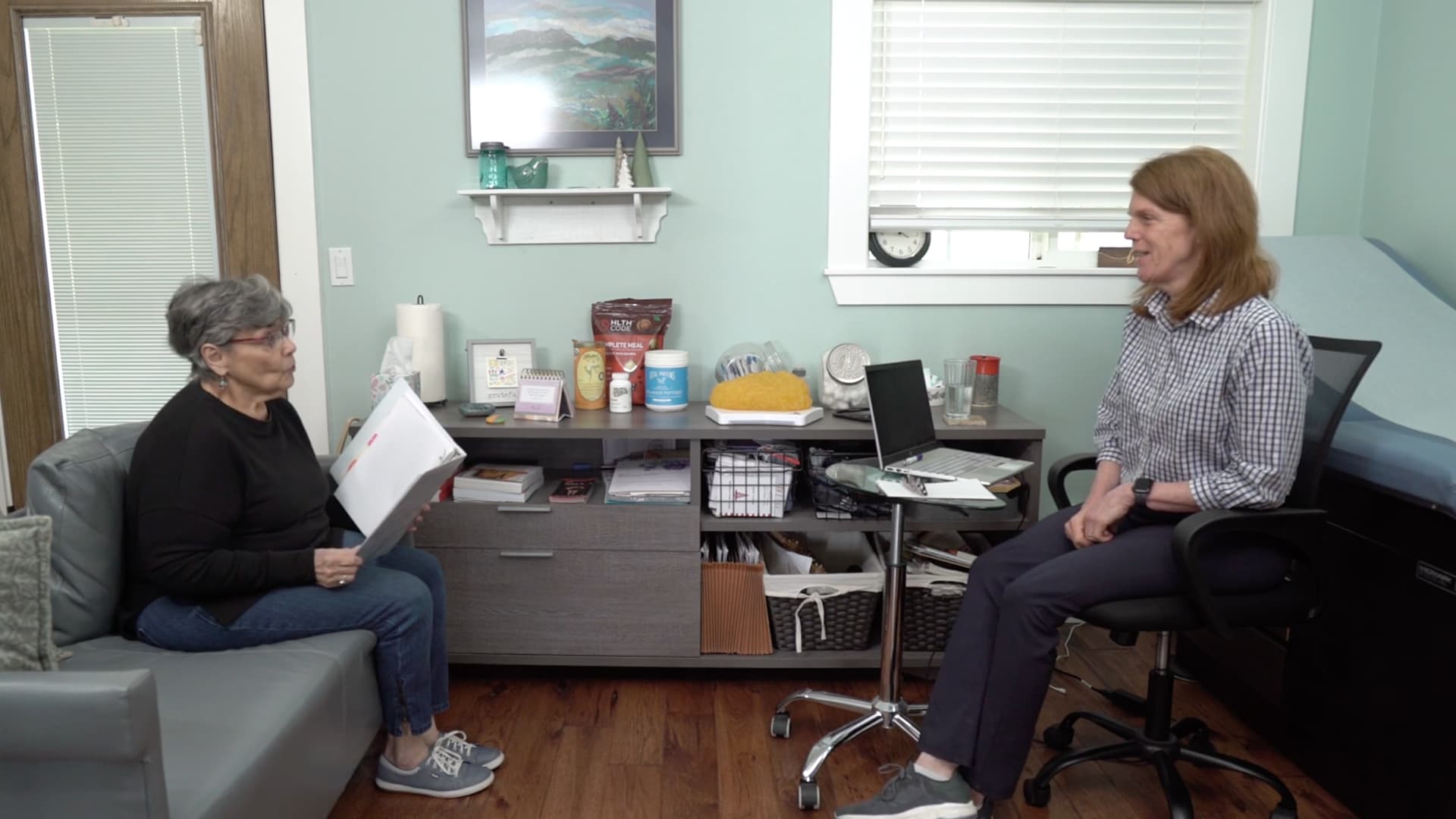 Dr. Gilbert consults with patient in her office